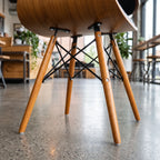 Product view of a modern wood-look dining side chair