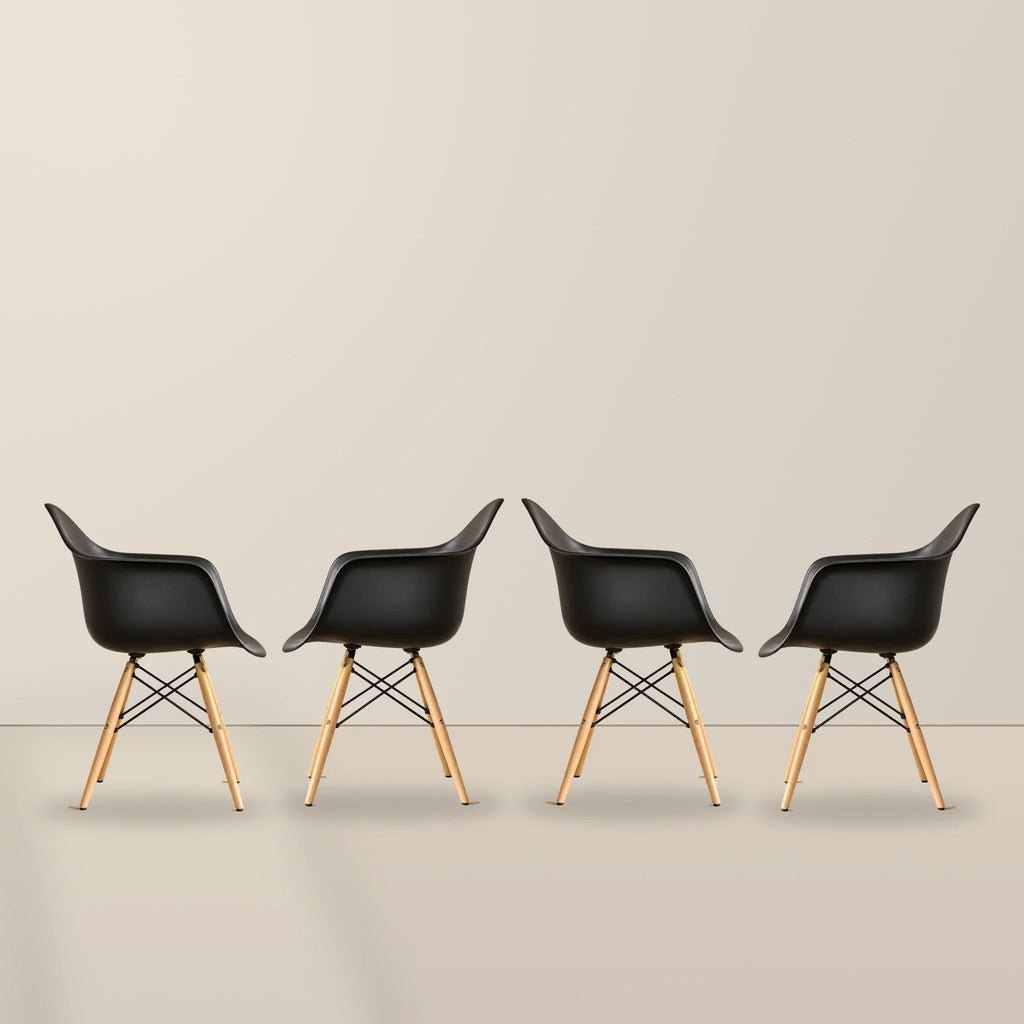 Four black Eames DAW dining armchairs with beech wood legs, illustrative studio set of 4