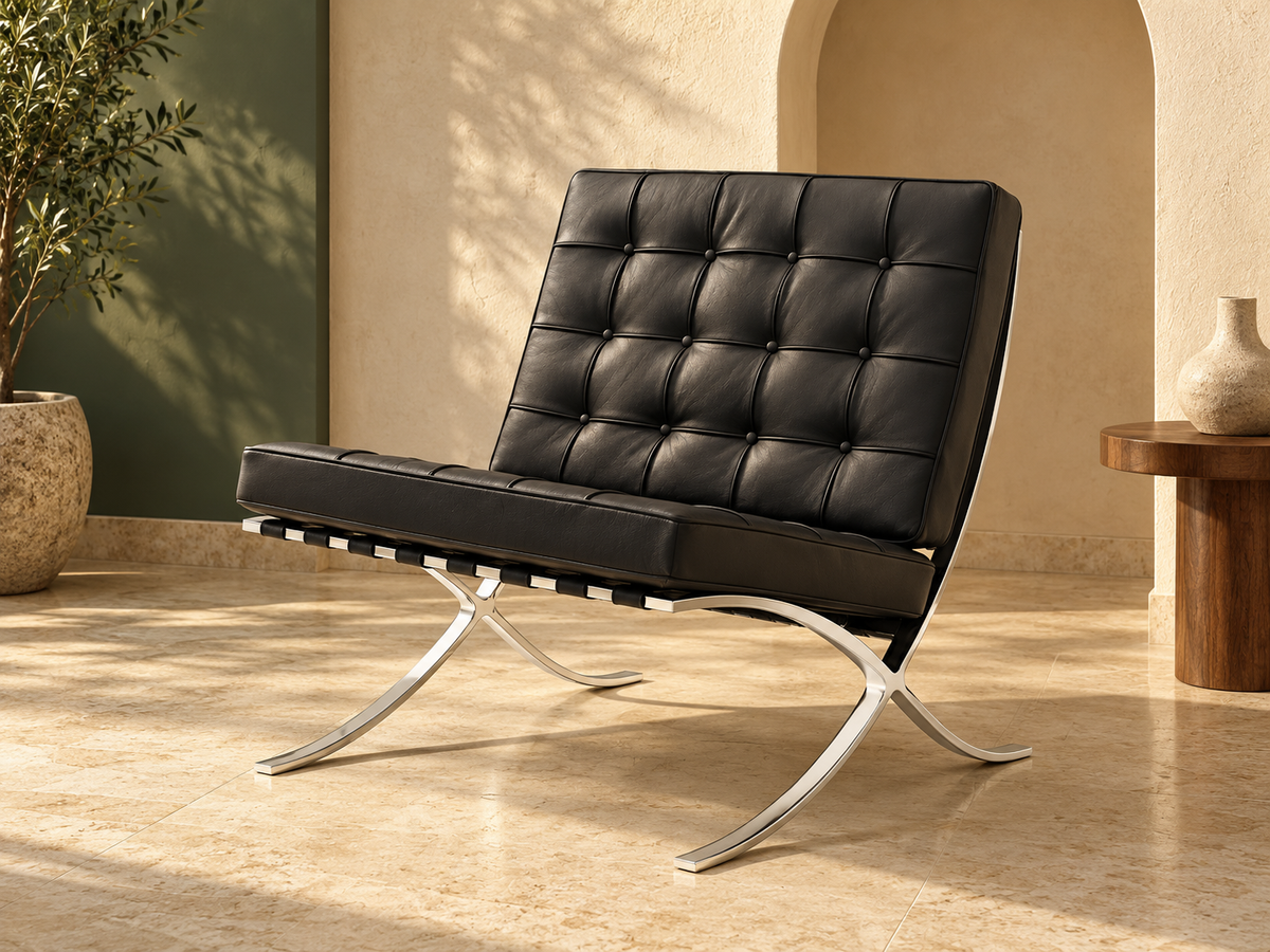 Black tufted leather and chrome Barcelona-inspired chair in a warm cream and olive interior